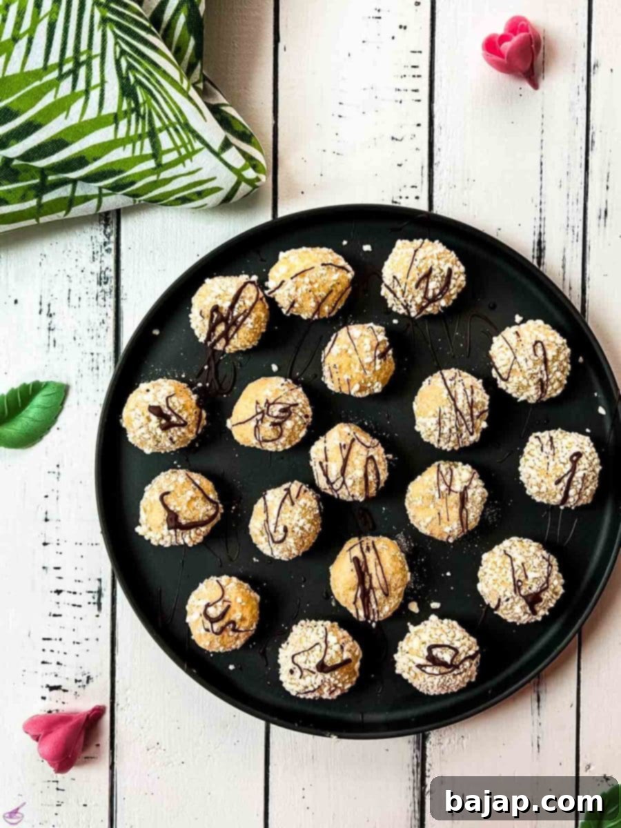 Gorgeous mascarpone eggnog cookies, rolled in ladyfinger crumbs and drizzled with chocolate sauce.