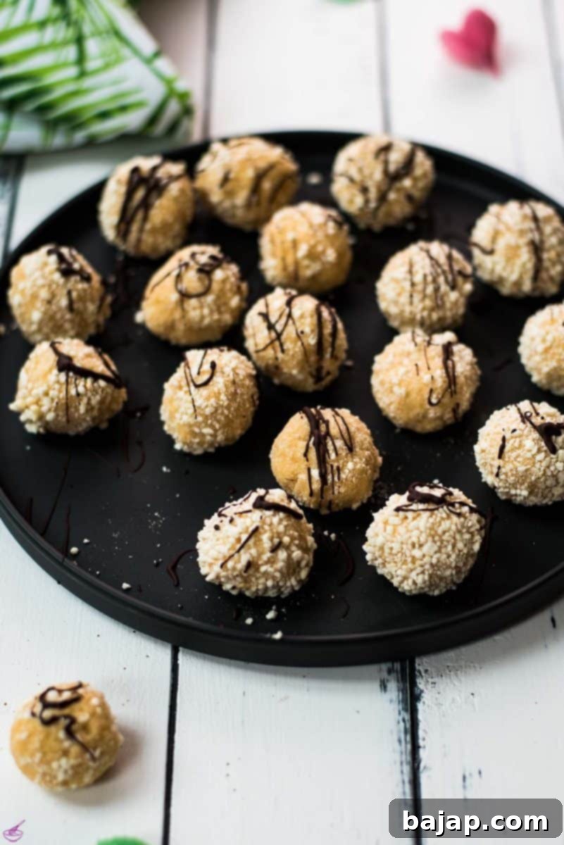 Gorgeous mascarpone eggnog cookies, rolled in ladyfinger crumbs and drizzled with chocolate sauce.