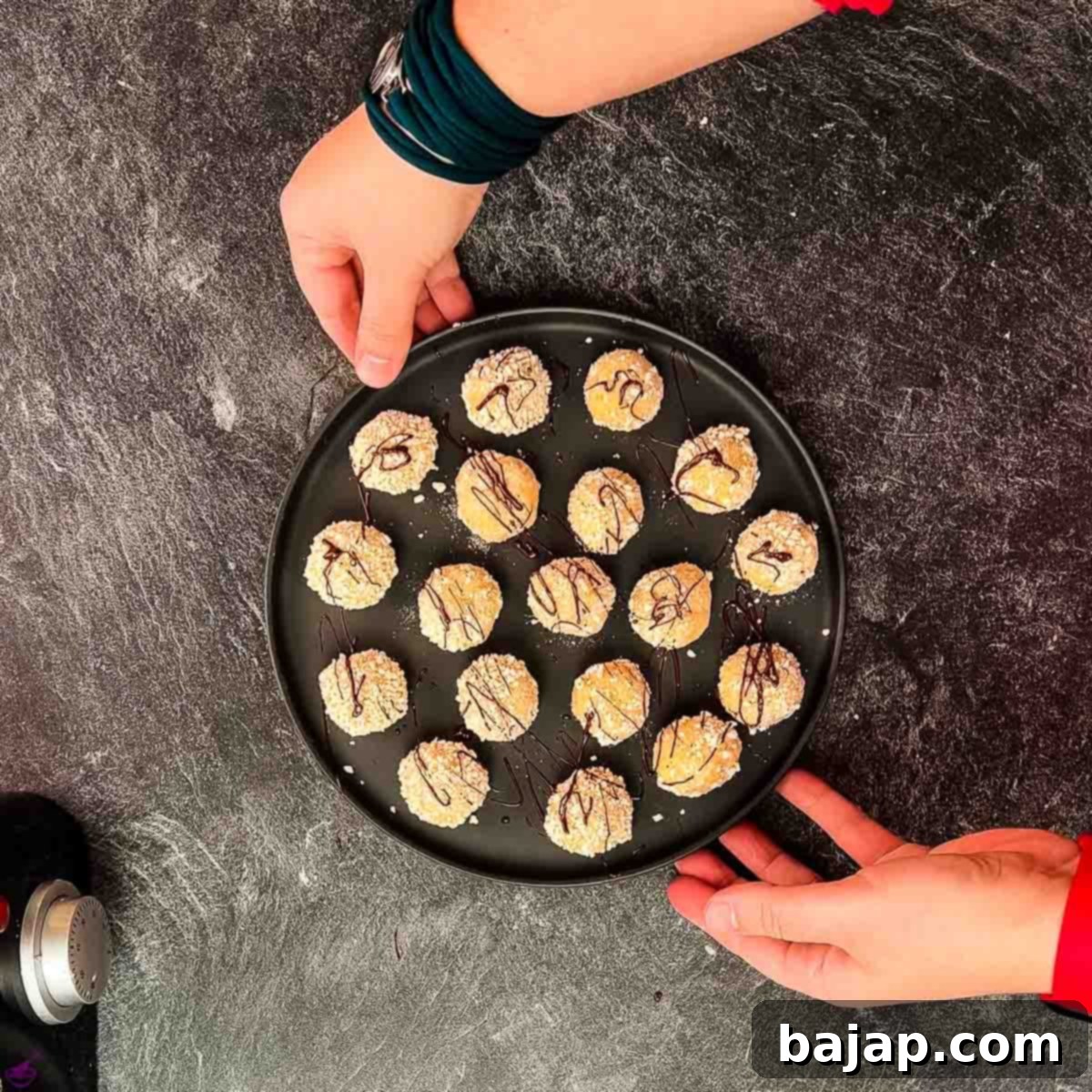 Gorgeous mascarpone eggnog cookies, rolled in ladyfinger crumbs and drizzled with chocolate sauce.