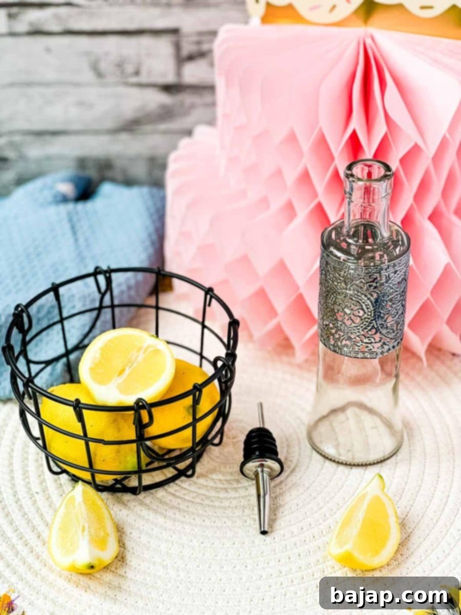 Lemons in wire basket next to bottle and pouring spout.