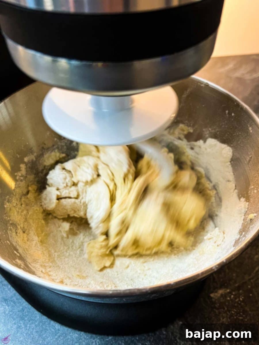 Add all-purpose flour and cornstarch using a dough hook to create the cookie dough.