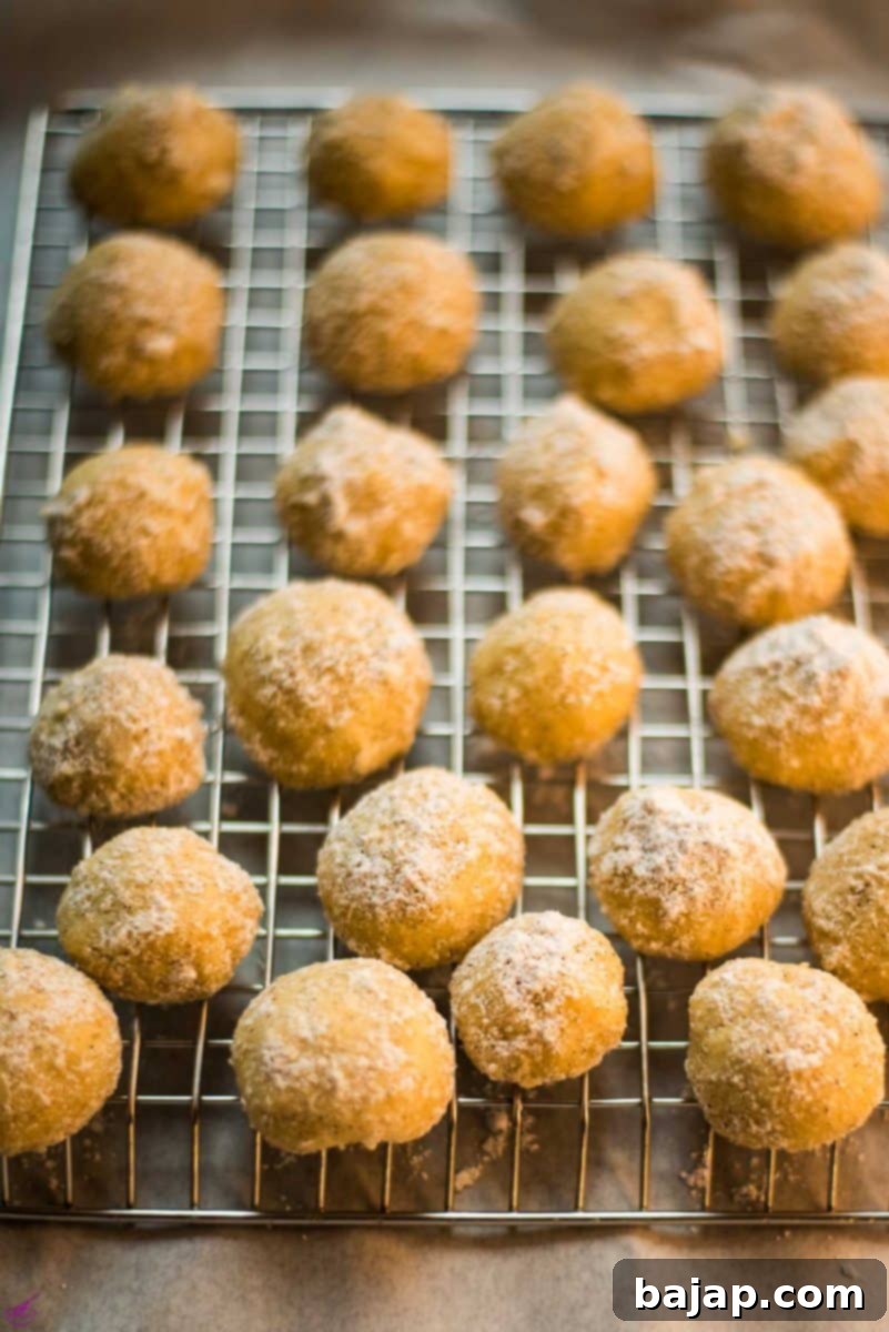 Finished butterball cookies on cooling rack.