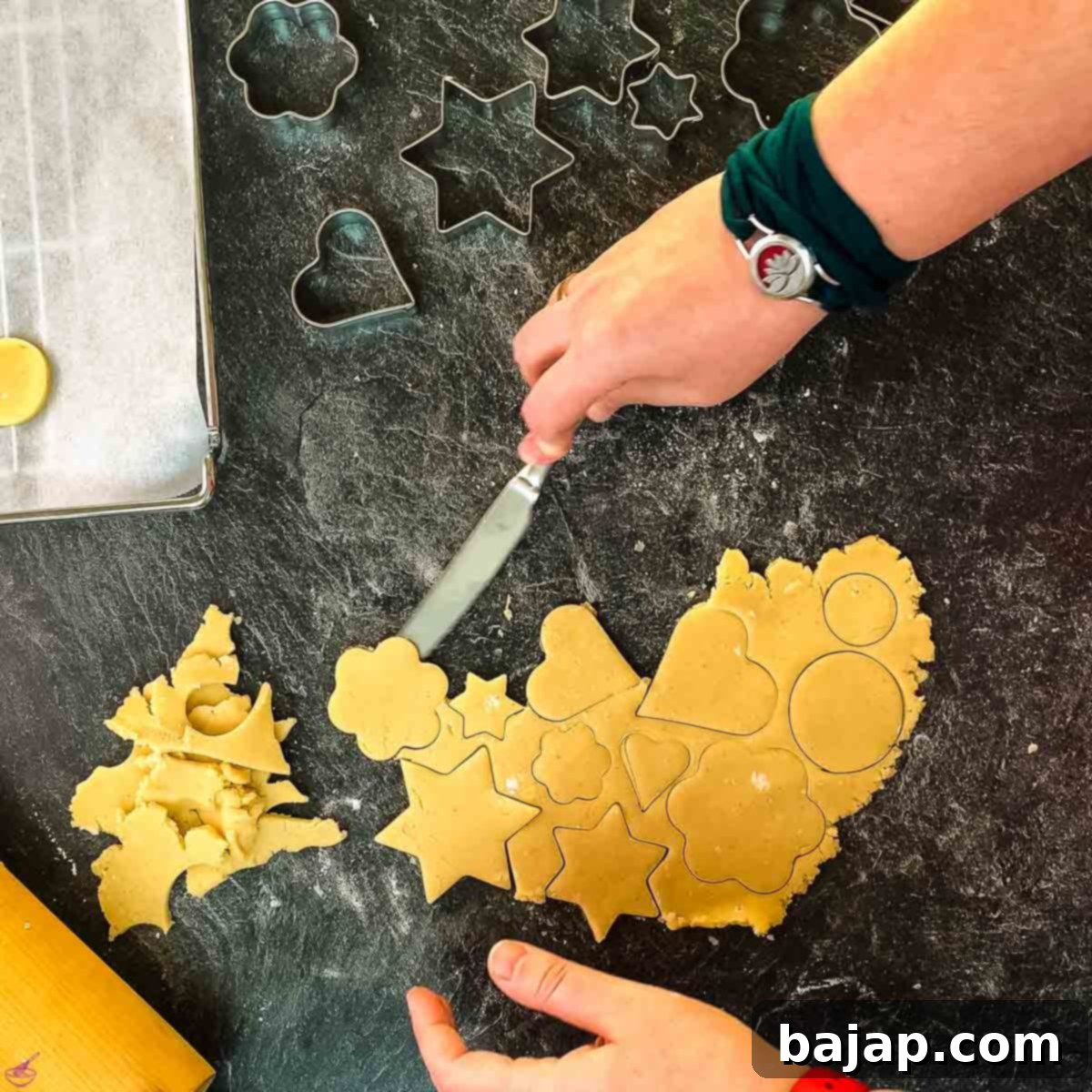 If you don't have a spatula, use a butter knife to loosen the cut-out cookies from the kitchen counter surface.