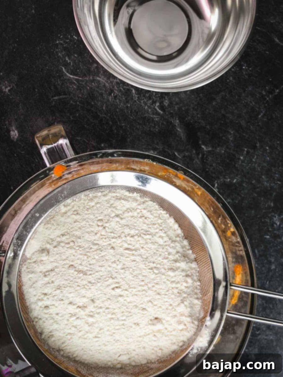 Taste Autumn's Warmth: Unbelievably Soft Pumpkin Cookies 9 Sieve the combined dry ingredients into the pumpkin cream mixture.