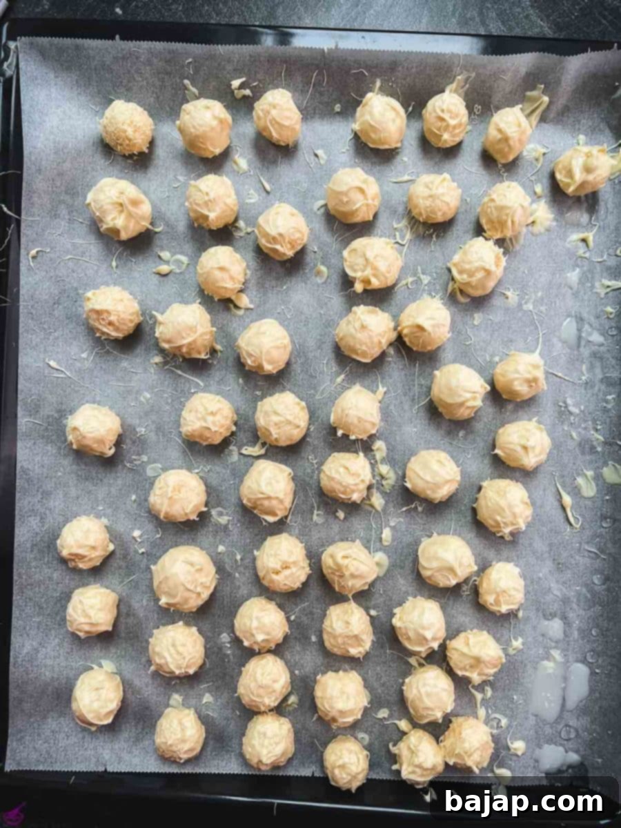 Let the covered truffles firm up on a baking sheet covered with parchment paper.