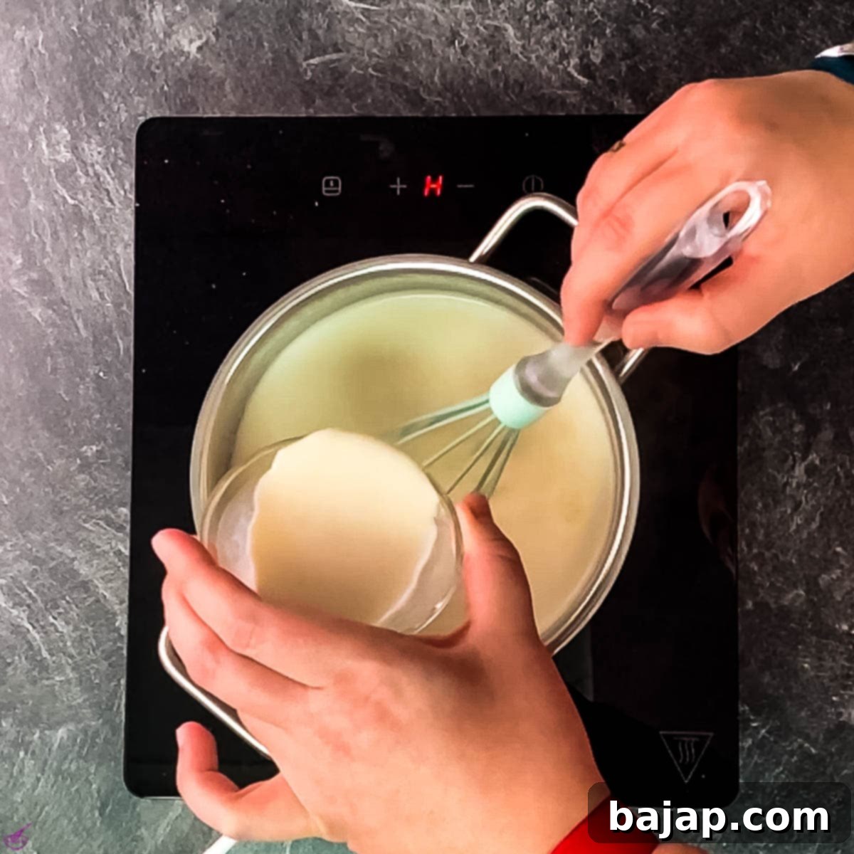 Carefully add the prepared cornstarch slurry to the gently boiling white chocolate mixture, stirring constantly.