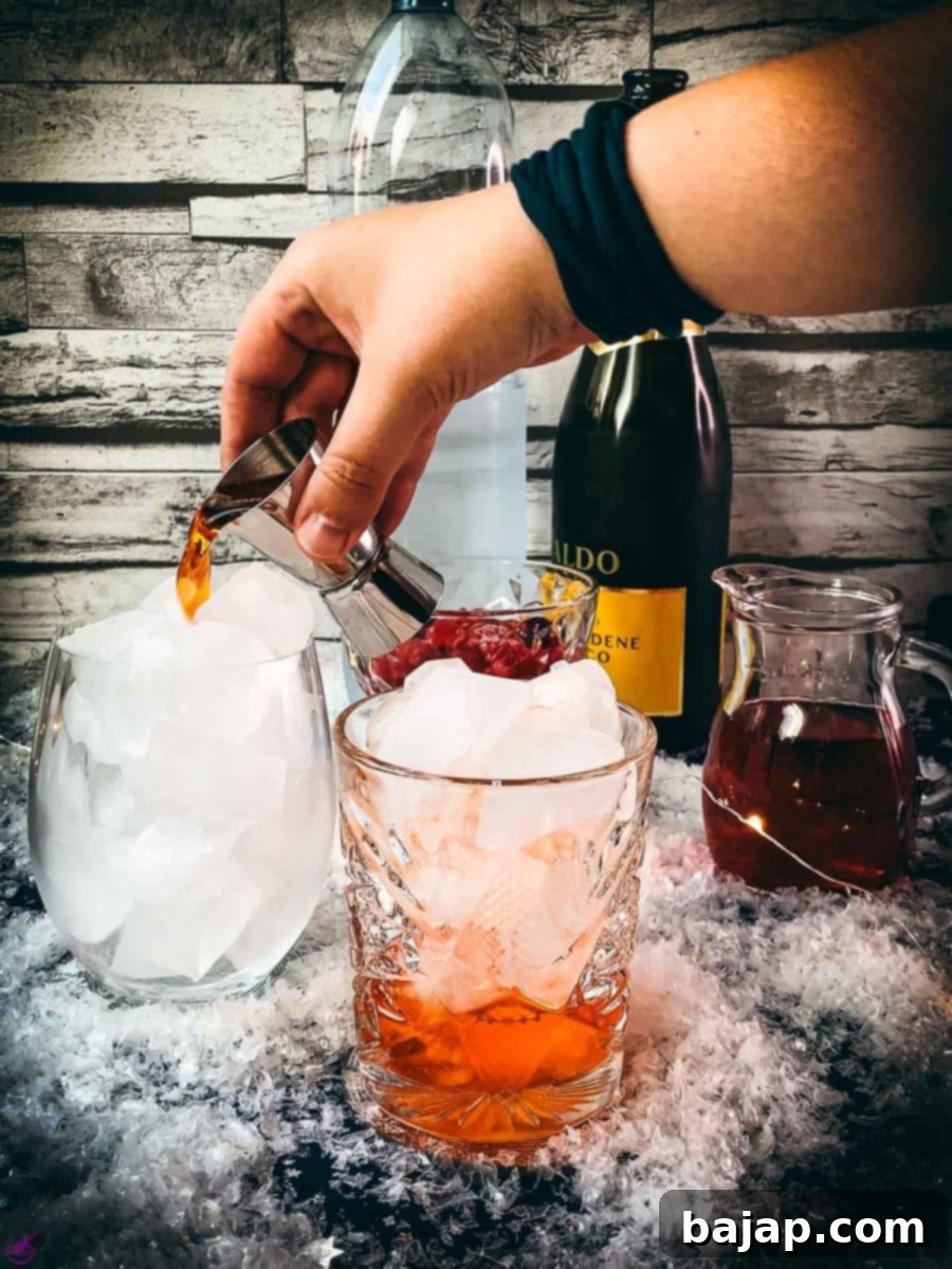 Add the Aperol to the glasses filled with cubed ice.
