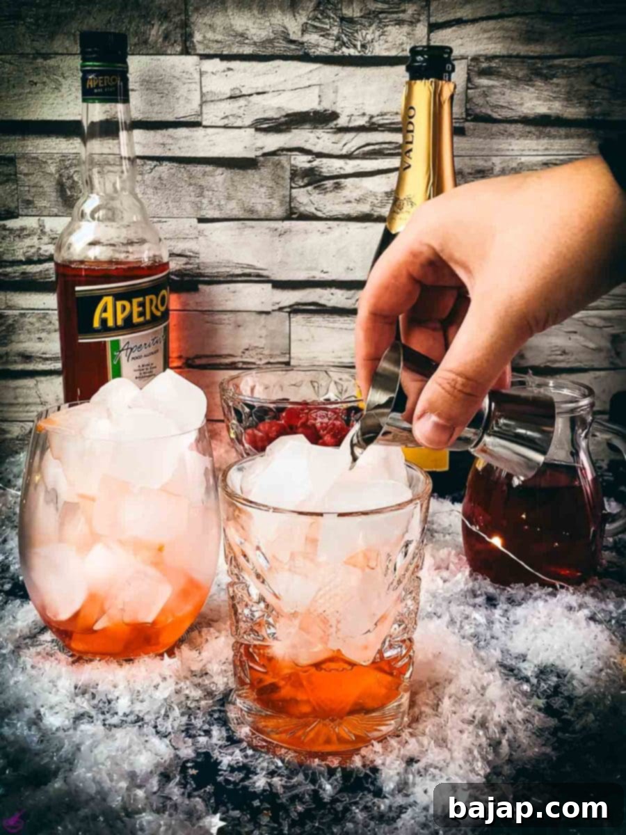 Pour soda water gently into the glass with Aperol and ice. The clear soda gradually mixes with the orange Aperol, maintaining the effervescence.