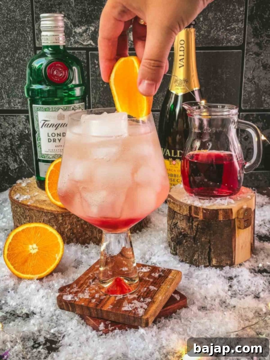 Garnish your cranberry gin spritz with a fresh slice of orange for a beautiful and aromatic finish.