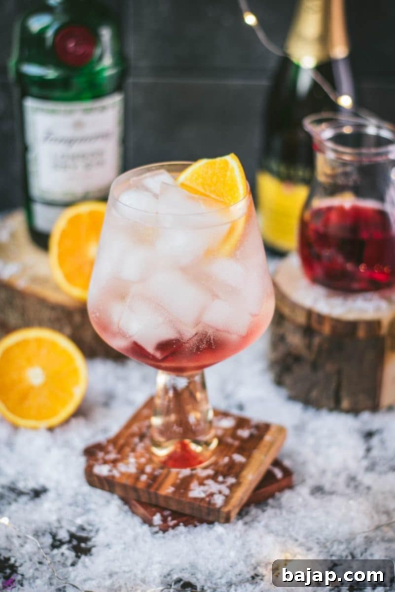 Stunning cranberry gin spritz, garnished with a slice of orange. Refreshing and festive!