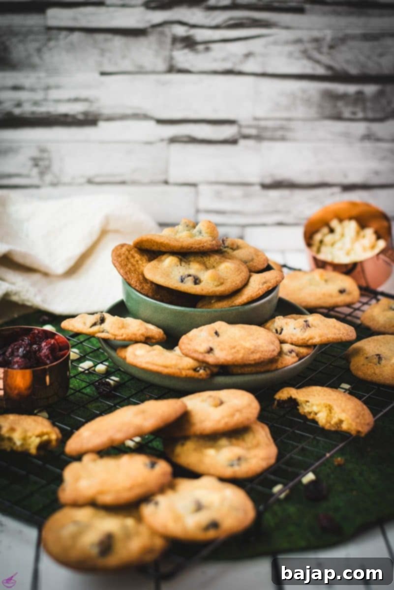 Freshly baked soft and chewy cranberry white chocolate chip cookies ready to be enjoyed.