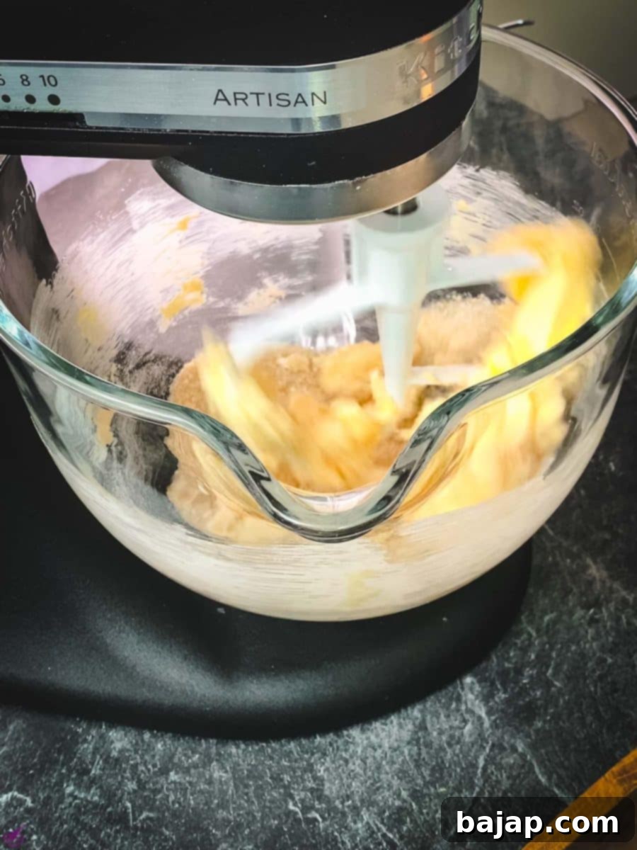 Creaming butter with brown and white sugars until light and fluffy.