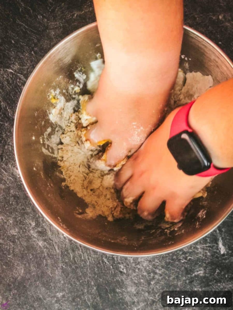Kneading the cookie dough by hand until it becomes smooth and pliable, ready for chilling.