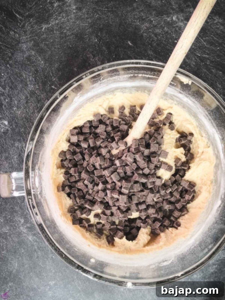 Adding rich dark chocolate chips to the rum-infused cookie dough for an extra layer of flavor and texture.