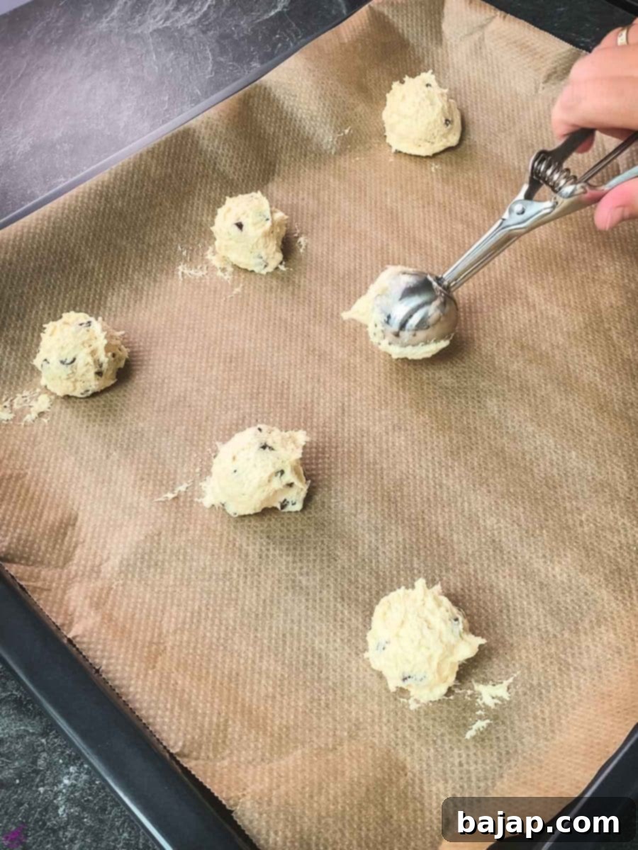 Scoop the dough into balls and evenly space them on a lined baking sheet.