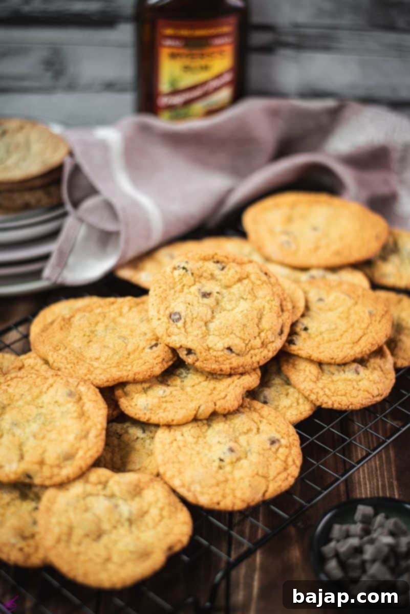 Delicious, perfectly golden rum chocolate chip cookies cooling on a wire rack, ready to be devoured.