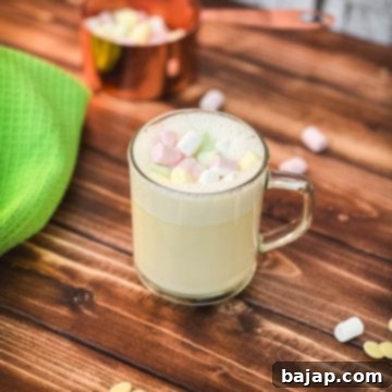 Glass cup filled with scrumptious white hot chocolate, topped with frothed white chocolate and garnished with mini marshmallows.