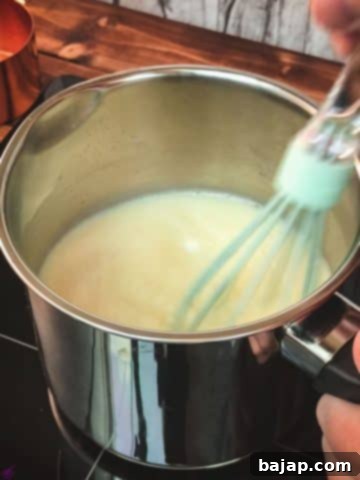 Combine the milk with the white chocolate chips, using a whisk.