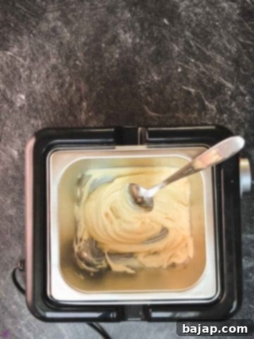 Melt the white chocolate in a tempering device, microwave, or double-boiler until smooth.