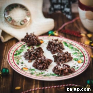 Christmas plate filled with dark chocolate clusters, on brown wooden background, next to Christmas decorations.