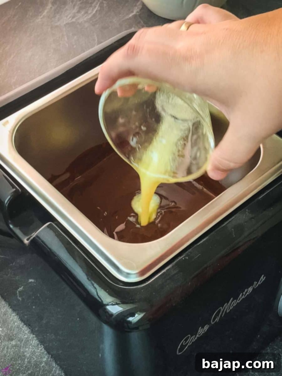 Add the melted butter to the melted chocolate.