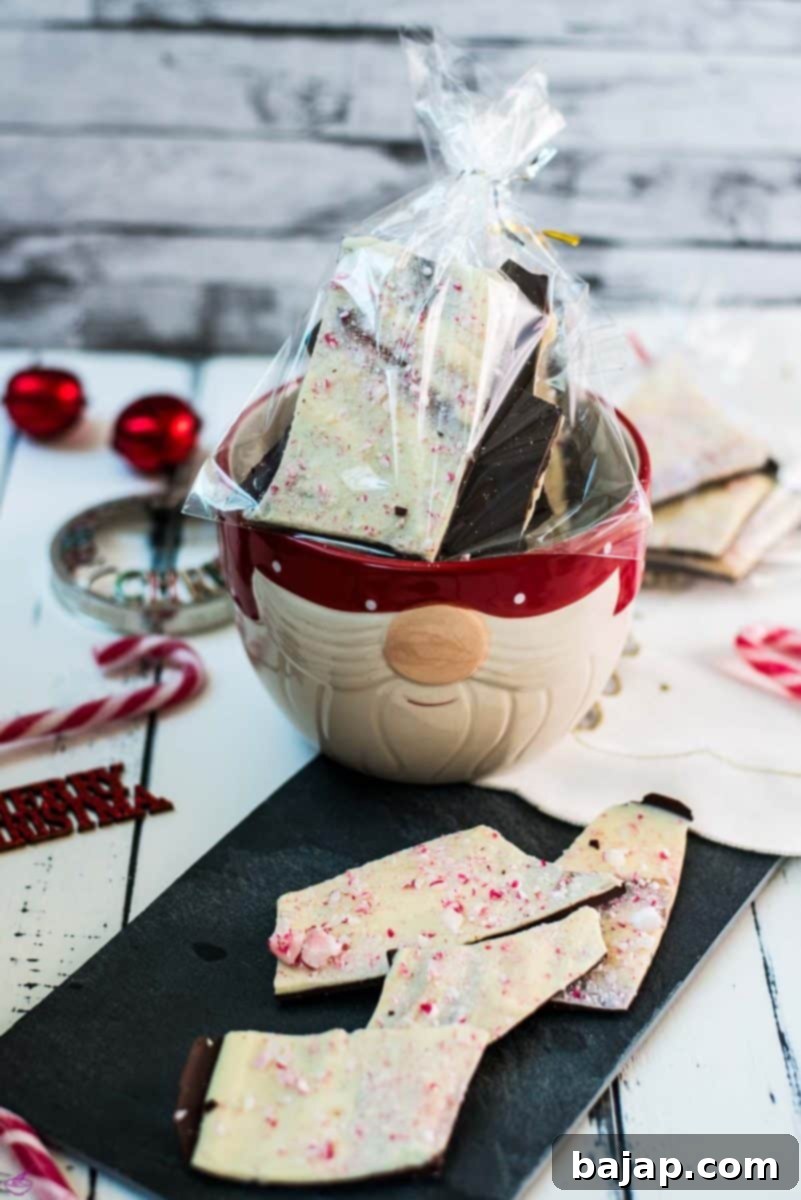 Beautiful black and white peppermint chocolate bark sprinkled with crushed candy canes. Placed in little gift bags.