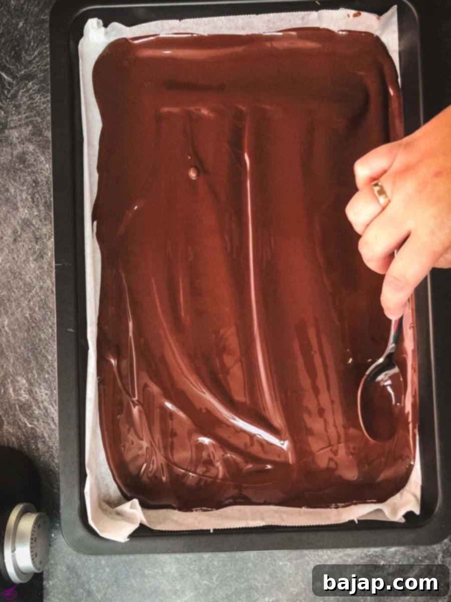 Spread the dark chocolate on a sheet pan, lined with parchment paper.