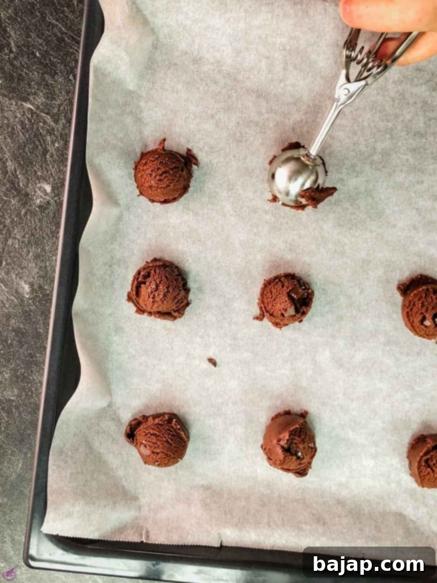 Scoop the cookie dough on the baking sheet lined with parchment paper.