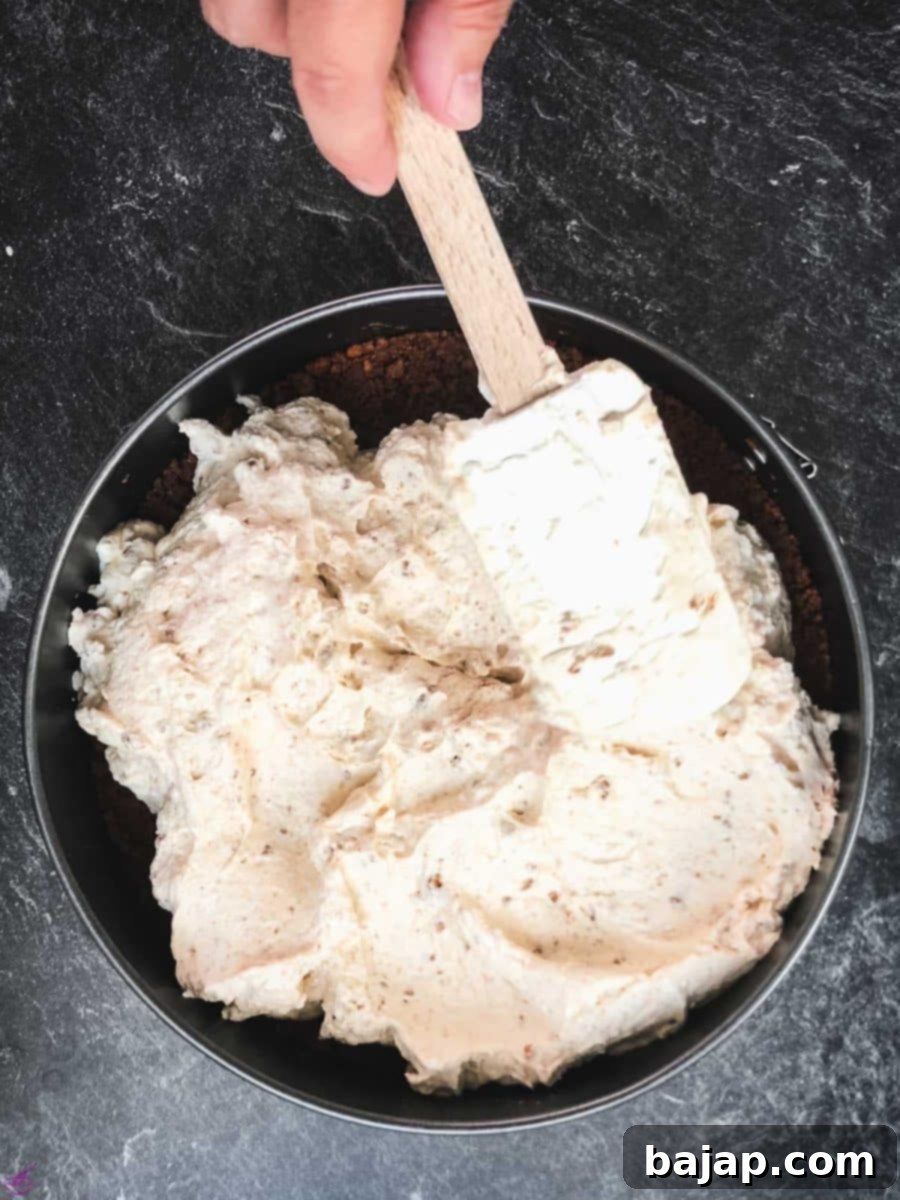 Biscoff Cheesecake Magic Without the Oven 6 Even out the top of the cream cheese filling using a spatula.