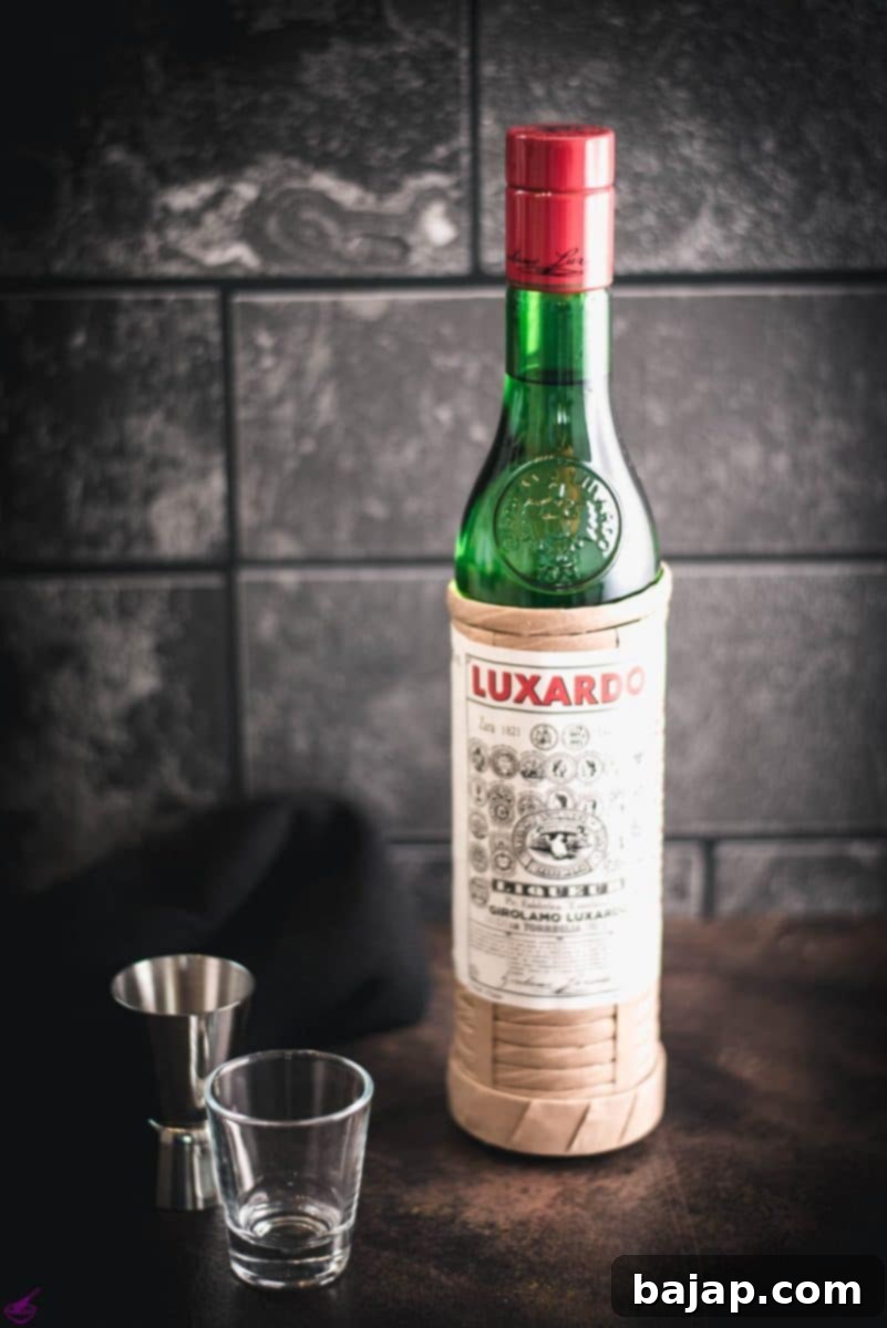 Luxardo Maraschino Liqueur bottle, showcasing its iconic straw-wrapped design against a dark background, ready for crafting classic cocktails.