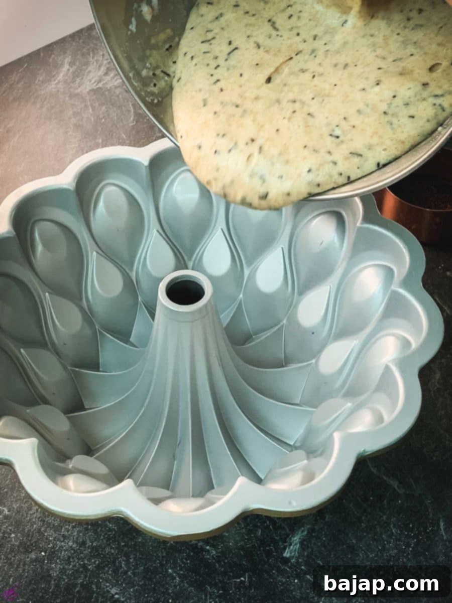 Pour half of the cake batter into the bundt cake pan.