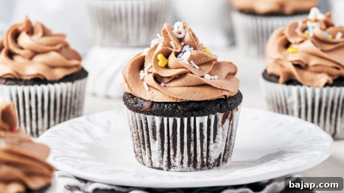 Decadent vegan chocolate fig cupcakes topped with creamy vegan Irish cream frosting, adorned with a fresh fig slice.
