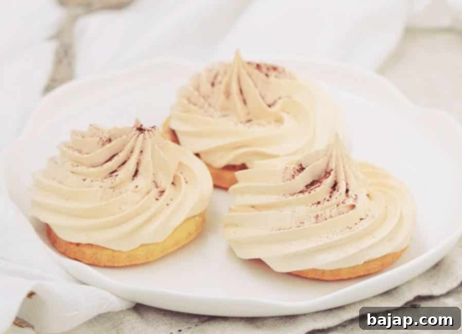 Light and airy meringue cookies, artfully piped, with a delicate caramel drizzle and a hint of fig jam peeking through, creating an elegant dessert.