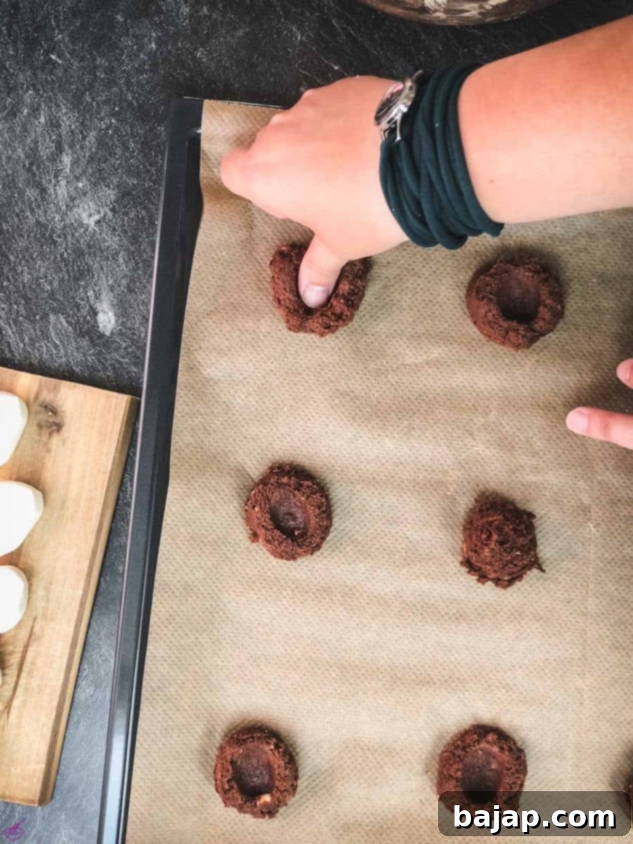 Make an indent with your thumb into the dark chocolate cookie dough scoops.