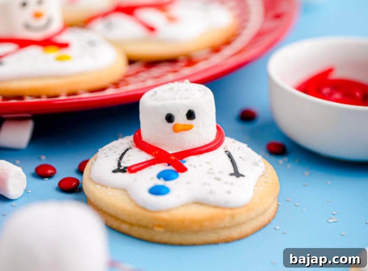 Cute melted snowman cookies, decorated with royal icing and garnishes.