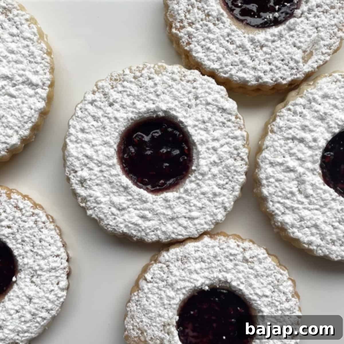 Shortbread Linzer cookies with raspberry filling, dusted with powdered sugar