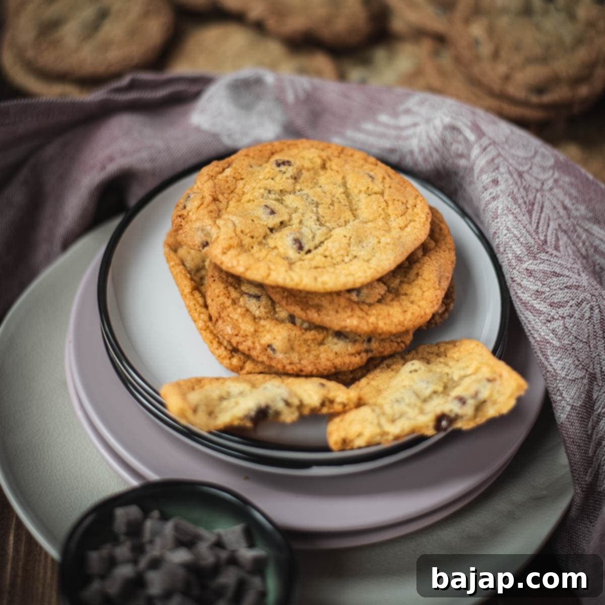 Delicious rum chocolate chip cookies placed on different colored and sized plates.