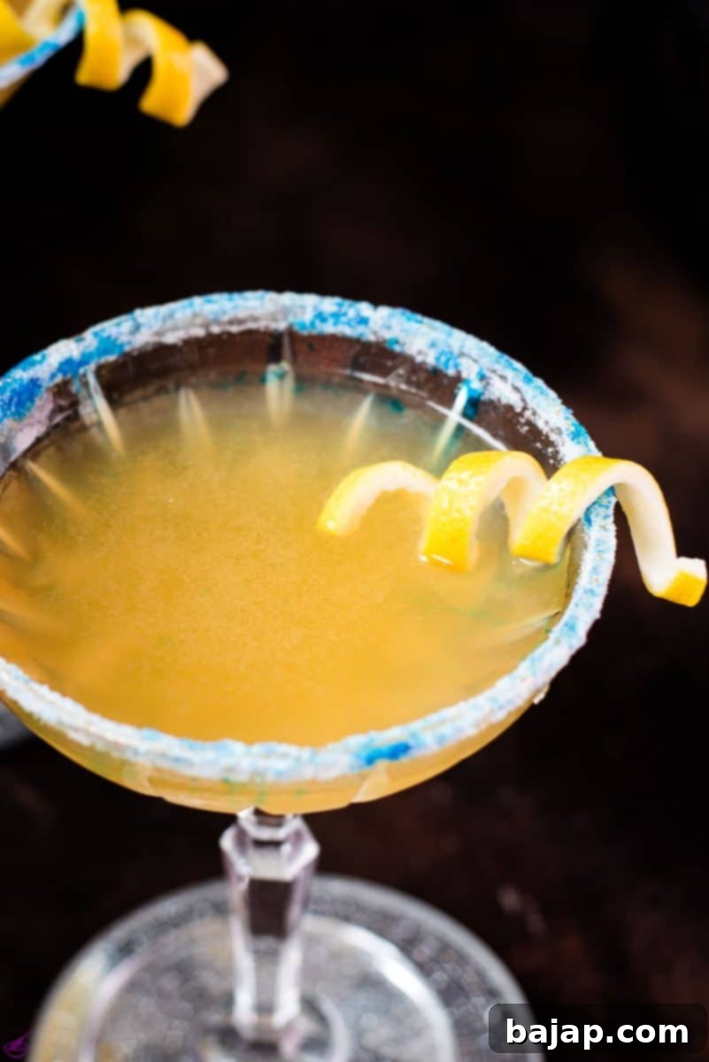 Whisky sidecar with gorgeous lemon twist and white blue sugar rim.