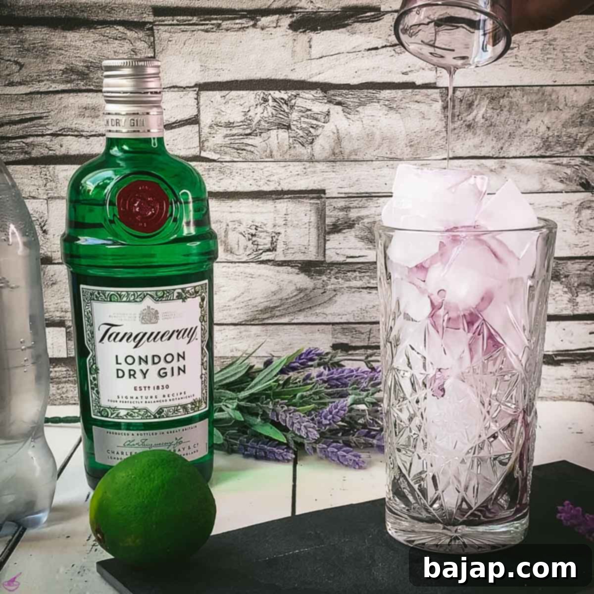 Lavender Gin and Tonic: Your Guide to Botanical Bliss 4 Adding lavender syrup to a highball glass filled with cubed ice.