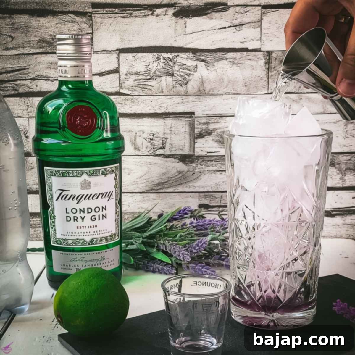 Lavender Gin and Tonic: Your Guide to Botanical Bliss 5 Adding gin to a highball glass.
