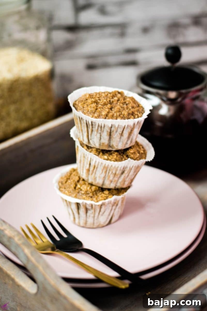 A magnificent tower of banana oatmeal muffins on a wooden tray. Behind it, delicious red tea.