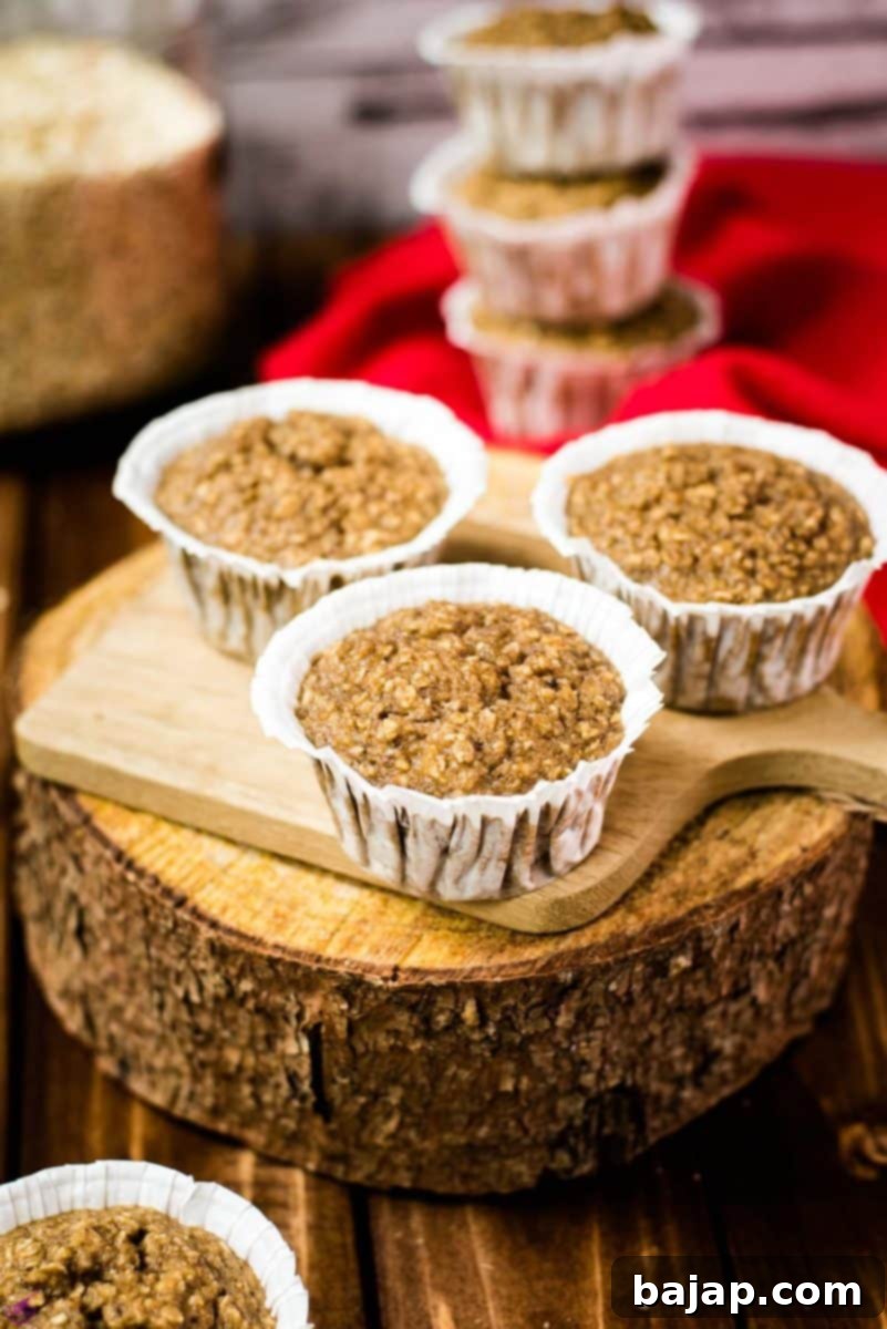 Three delicious banana oatmeal muffins on wodden board. Behind it, a magnificent tower of banana oatmeal muffins.