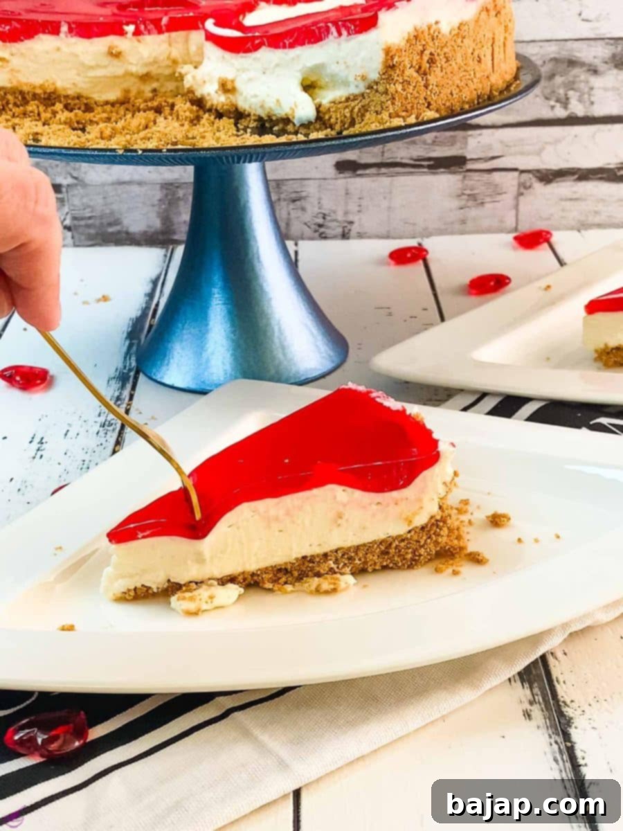 A slice of delicious Valentine's Raspberry Cheesecake placed on white plate next to a golden fork.