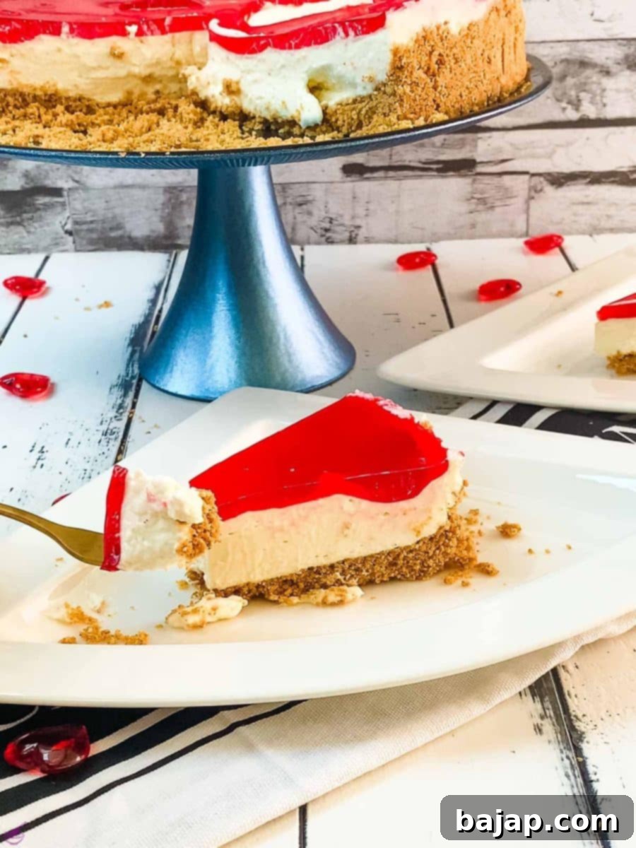 A slice of delicious Valentine's Raspberry Cheesecake placed on white plate next to a golden fork.