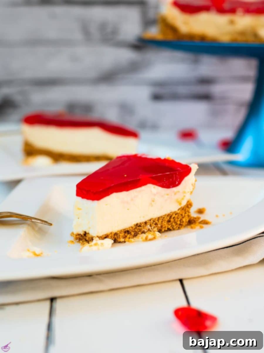 A slice of delicious Valentine's Raspberry Cheesecake placed on white plate next to a golden fork.
