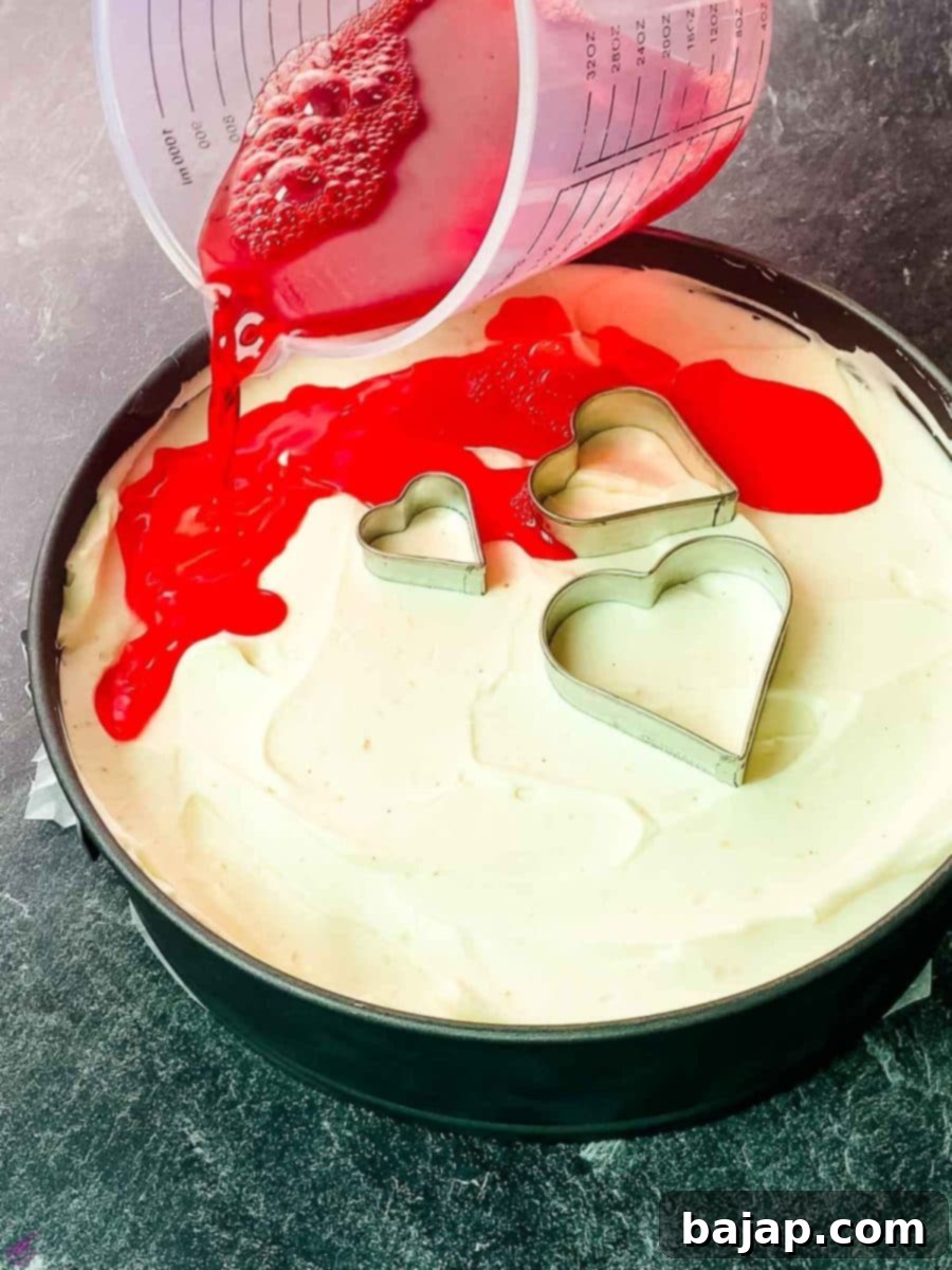 Pour the raspberry jello over the finished no bake cheesecake filling.