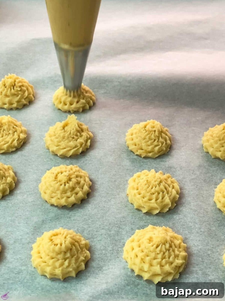 Pipe the lemon cookie dough on a baking sheet lined with parchment paper.