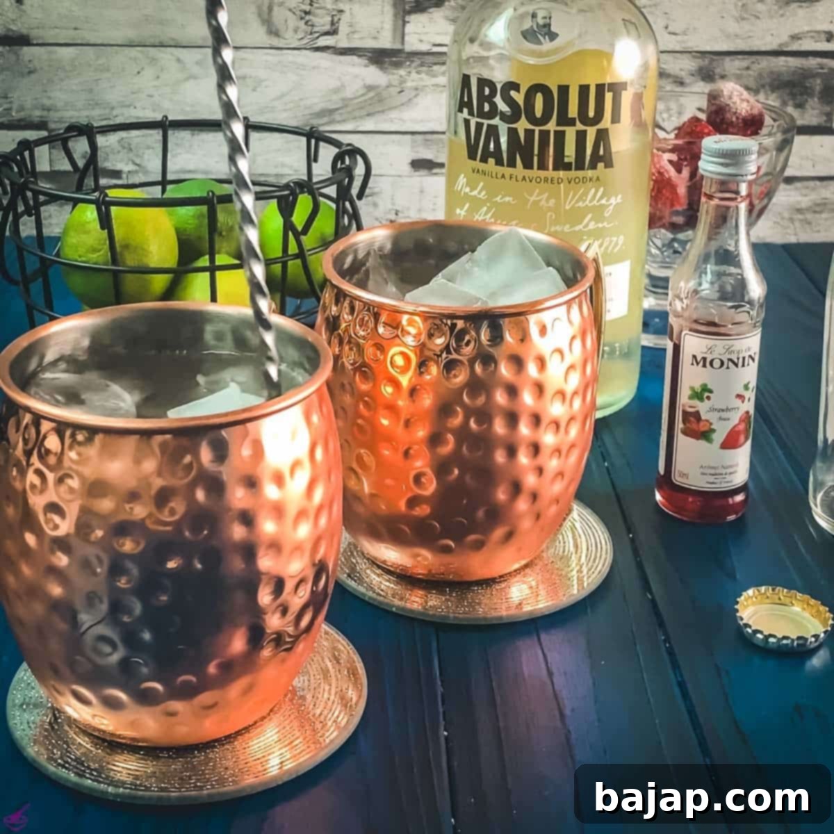 Stirring the strawberry Moscow mule with a bar spoon.