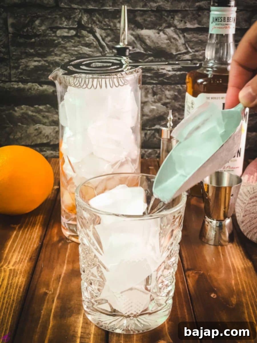 Adding a large, single ice cube to a rocks glass before pouring the cocktail.