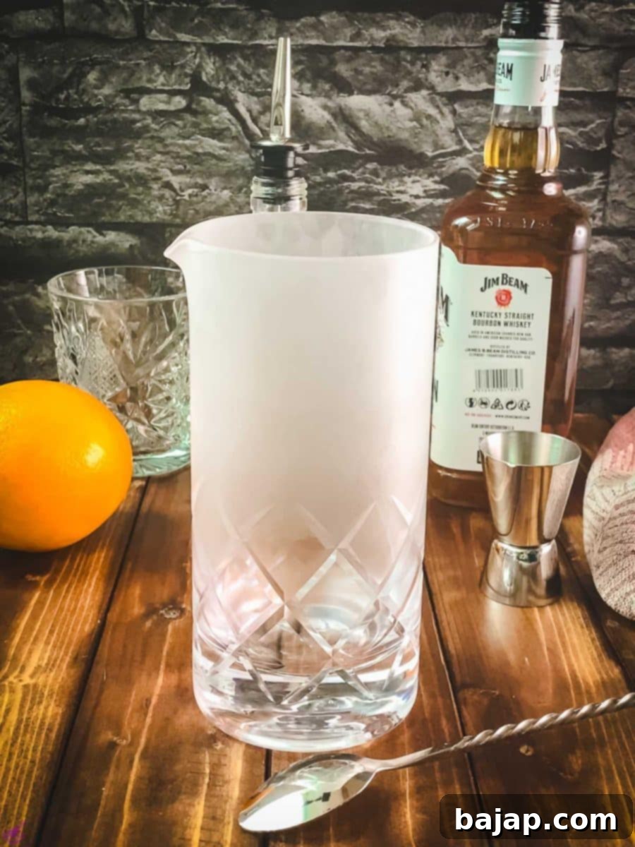 A chilled stirring glass being taken from the freezer, ready for cocktail preparation.